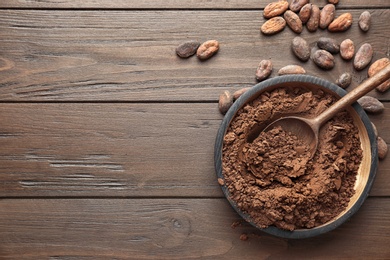 Photo of Flat lay composition with cocoa powder and beans on wooden background