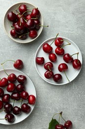 Photo of Fresh ripe cherries on light grey table, flat lay