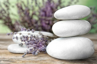Spa stones with lavender flowers on table
