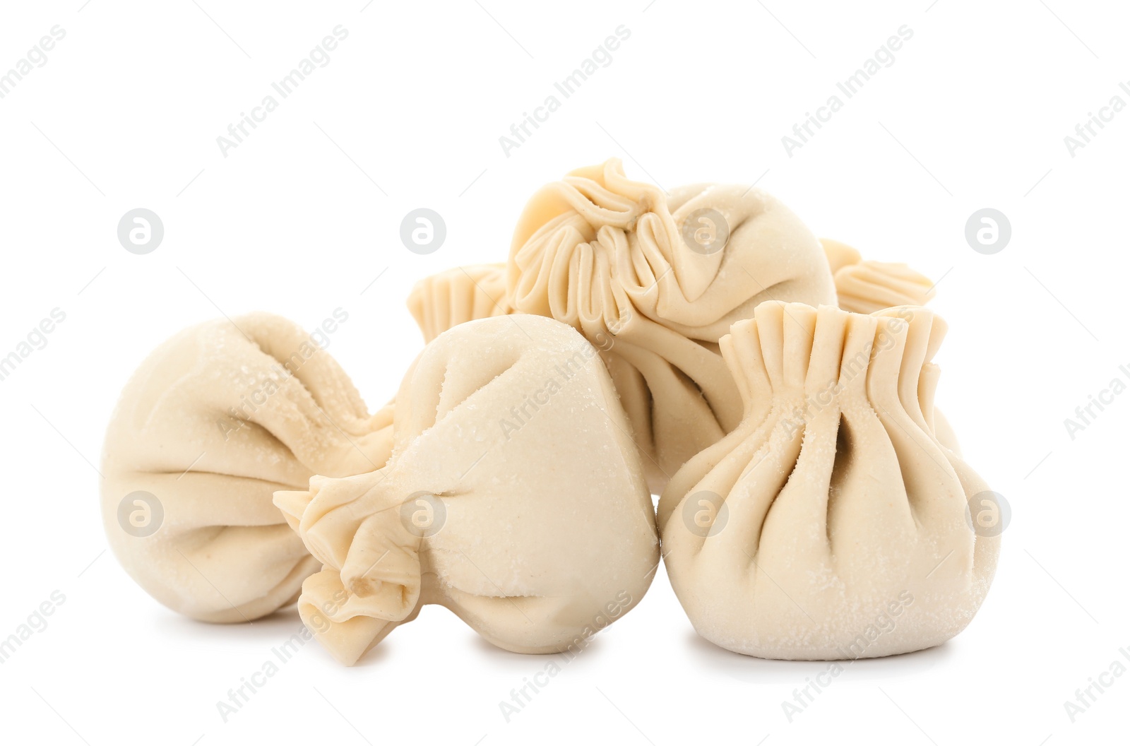 Photo of Heap of raw dumplings with tasty filling on white background