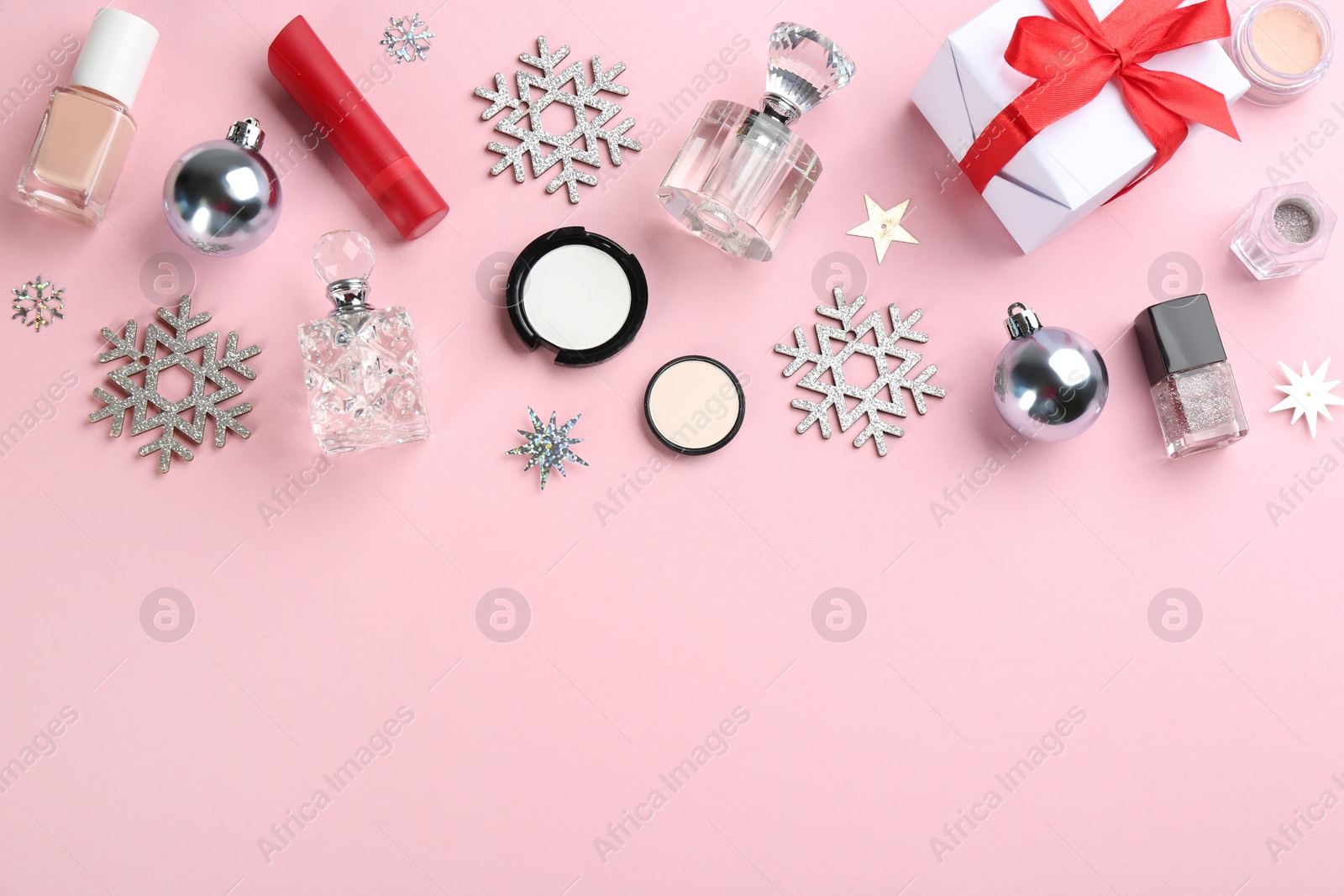 Photo of Flat lay composition with decorative cosmetic products on pink background, space for text. Winter care