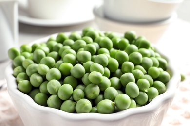 Photo of Bowl with delicious fresh green peas, closeup