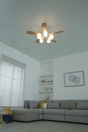 Comfortable furniture, ceiling fan and accessories in stylish living room