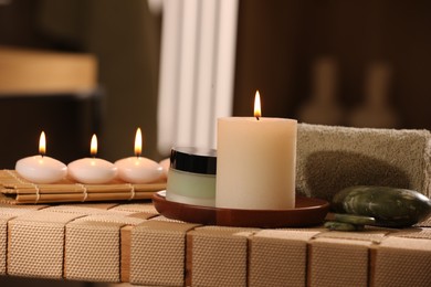 Beautiful composition with different spa products on wicker bench indoors