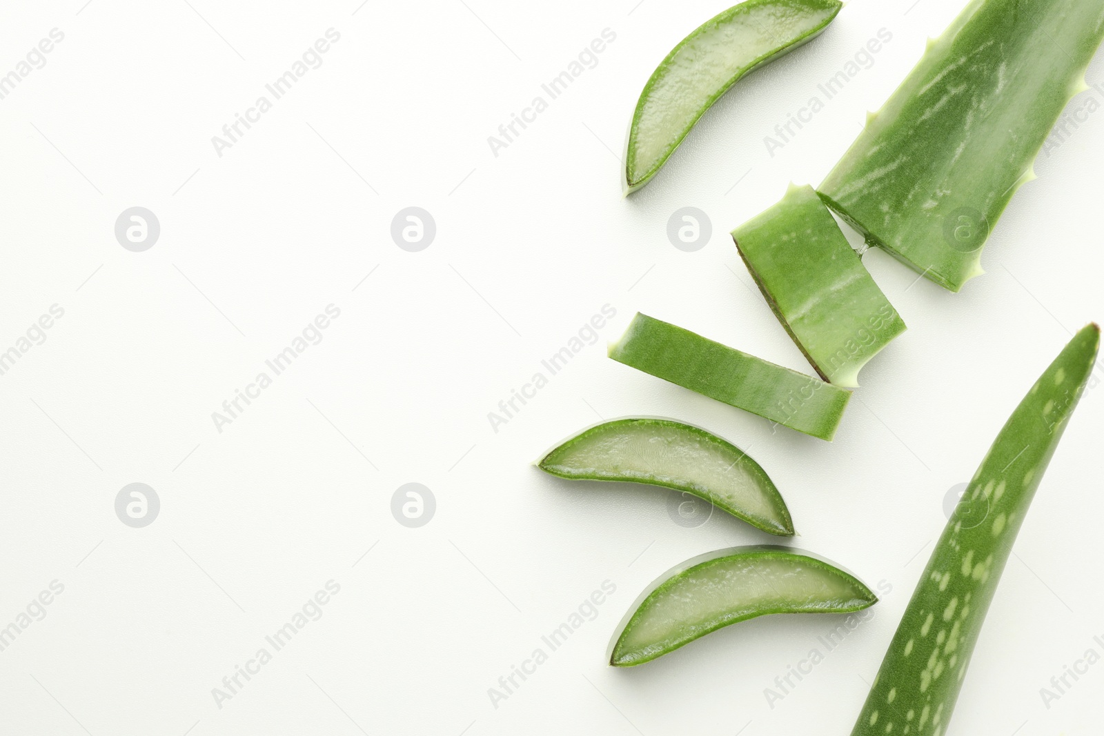 Photo of Fresh aloe vera pieces on white background, flat lay. Space for text