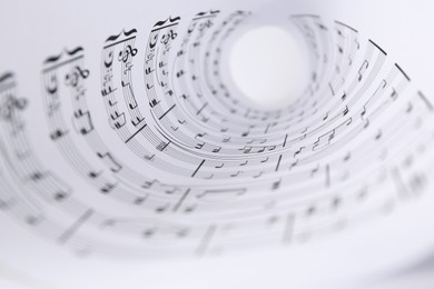 Rolled sheet with music notes, closeup view
