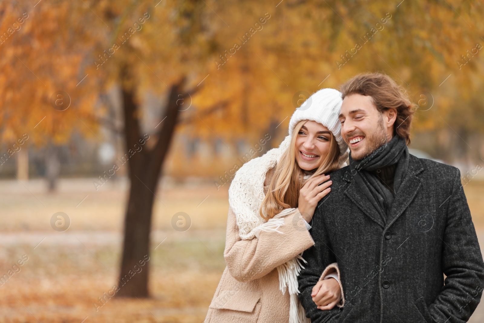 Photo of Young romantic couple in park on autumn day