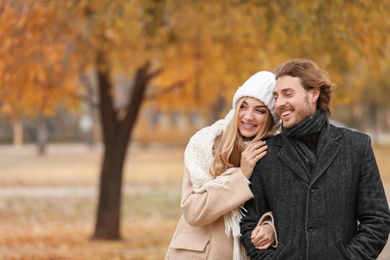 Young romantic couple in park on autumn day