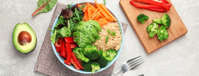 Image of Delicious vegan bowl with bell pepper, avocado and broccoli on grey table, flat lay. Banner design