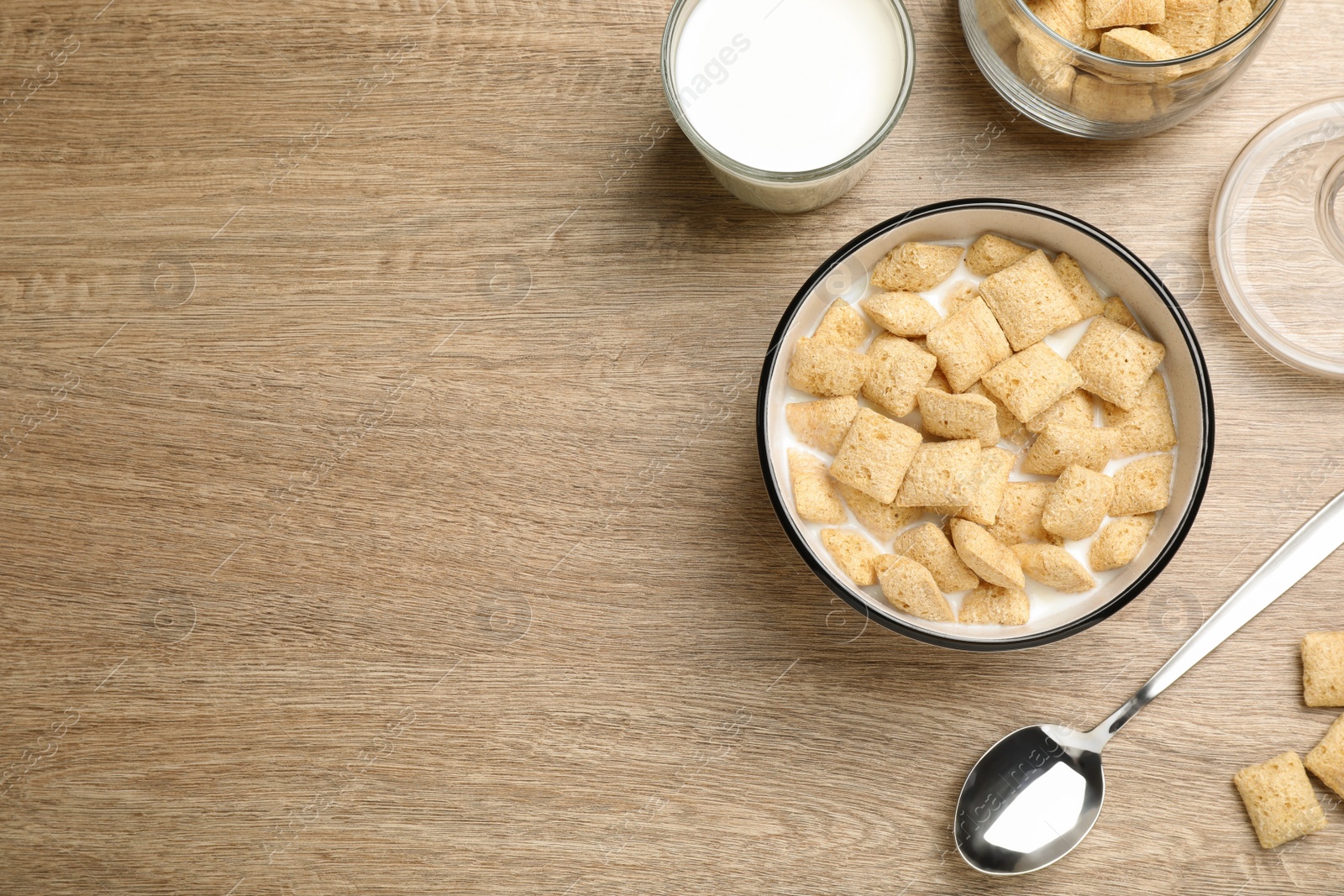 Photo of Tasty corn pads with milk served on wooden table, flat lay. Space for text