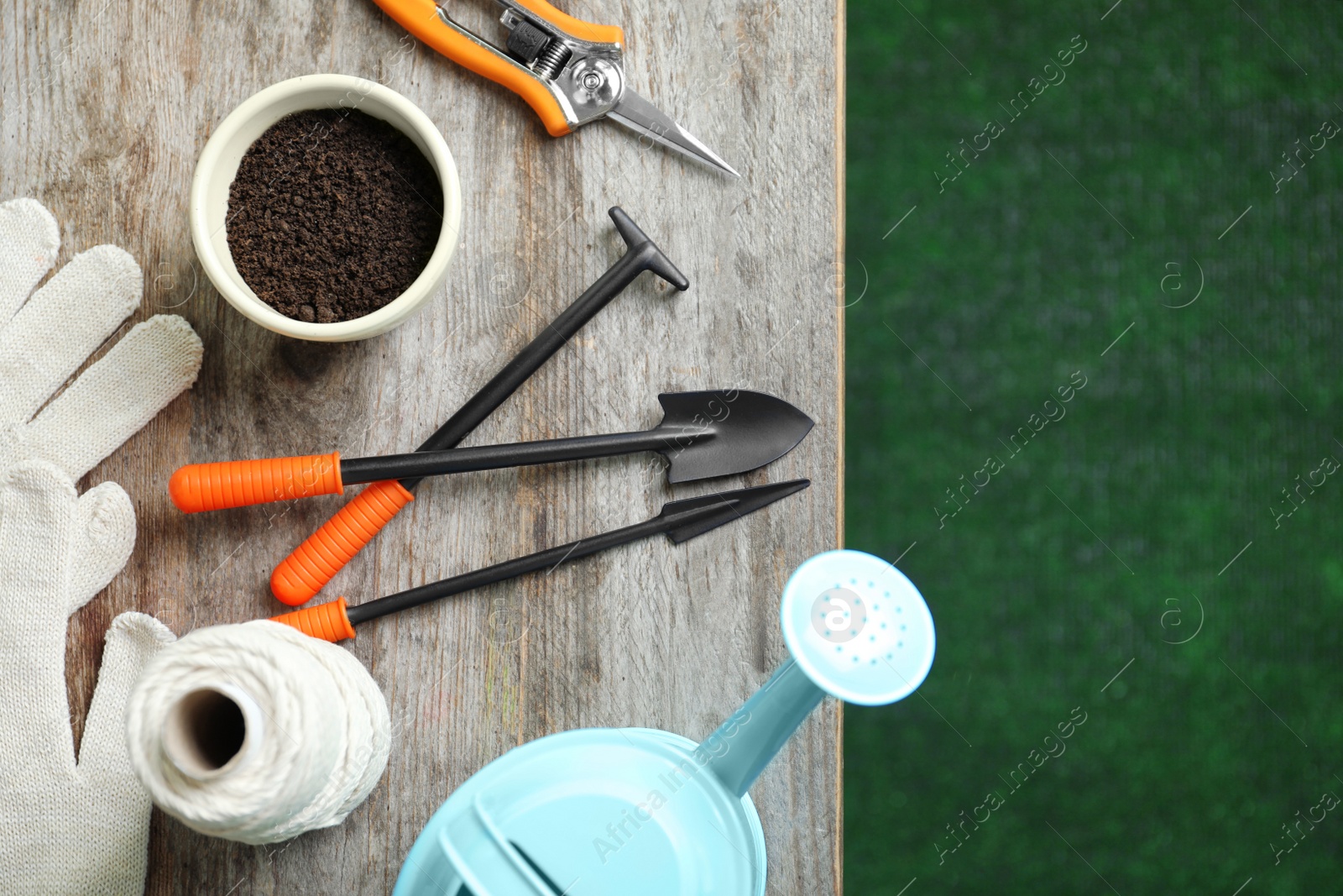 Photo of Flat lay composition with professional gardening tools on wooden table