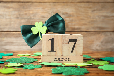 Photo of Composition with block calendar on wooden table. St. Patrick's Day celebration