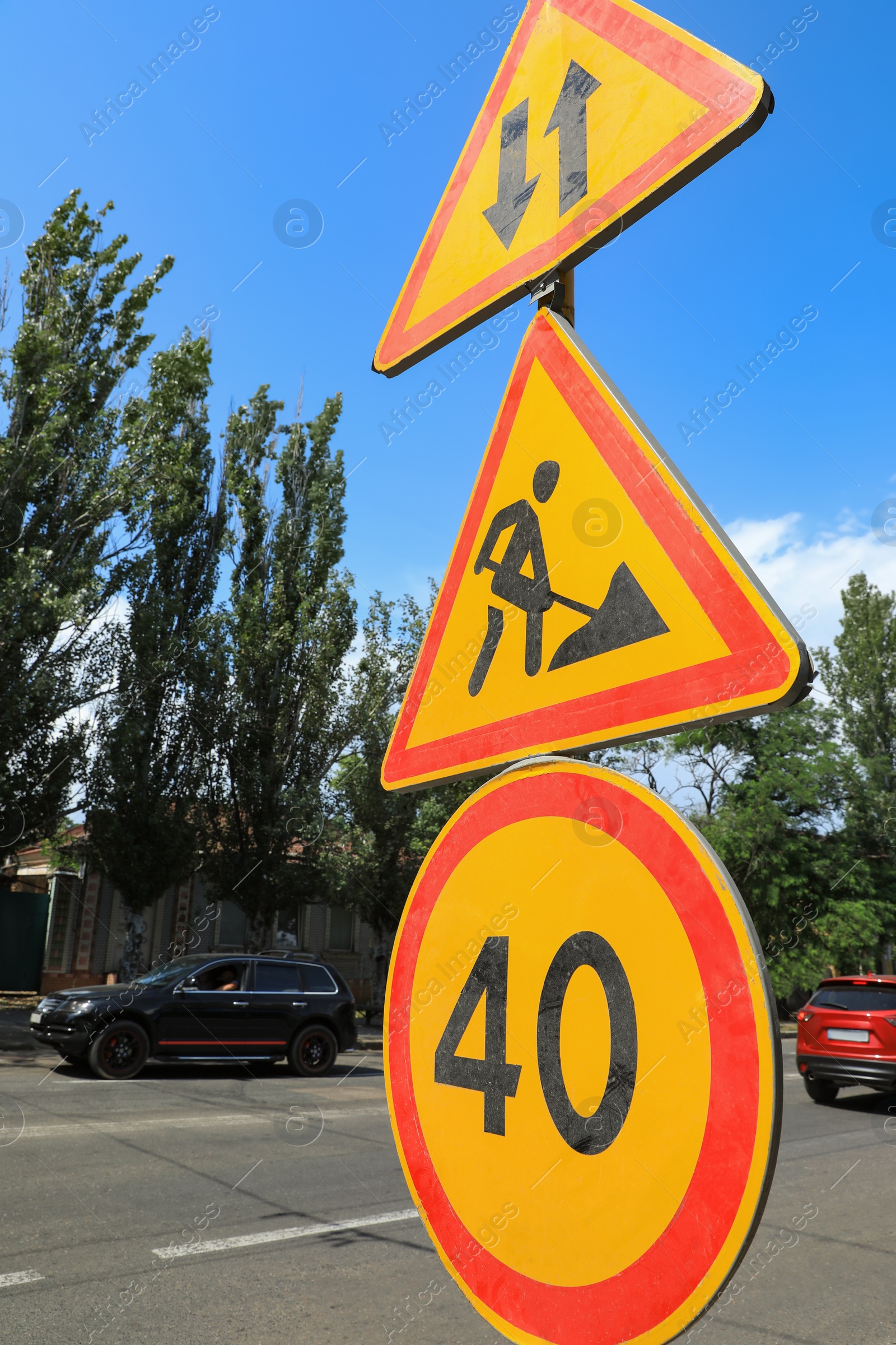 Photo of Traffic signs on city street. Road repair