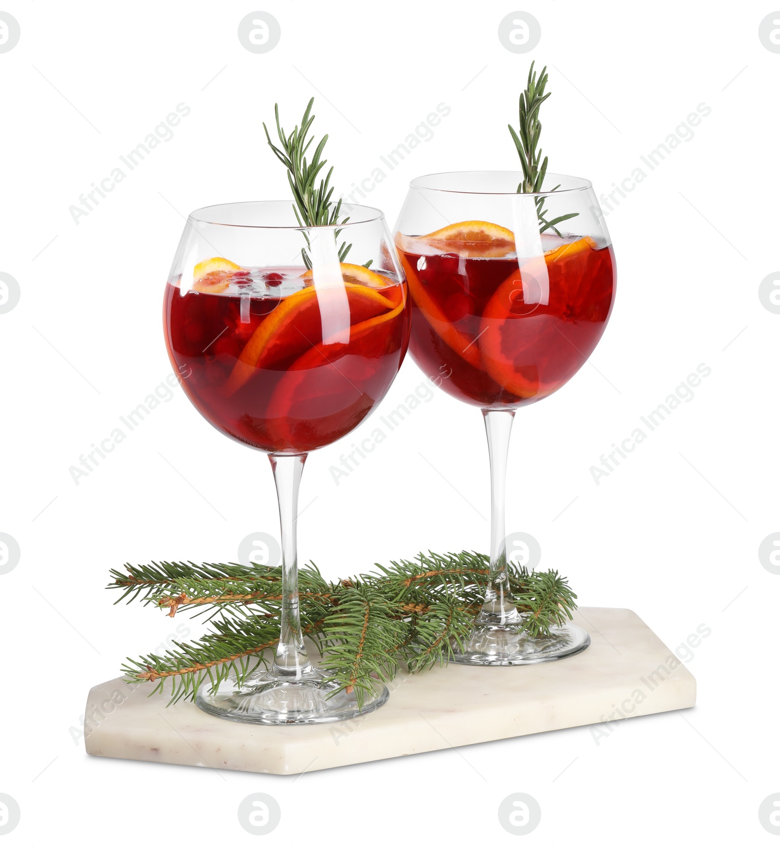 Photo of Christmas Sangria cocktail in glasses and fir tree branch isolated on white