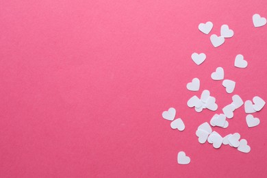 Photo of White paper hearts on pink background, flat lay. Space for text