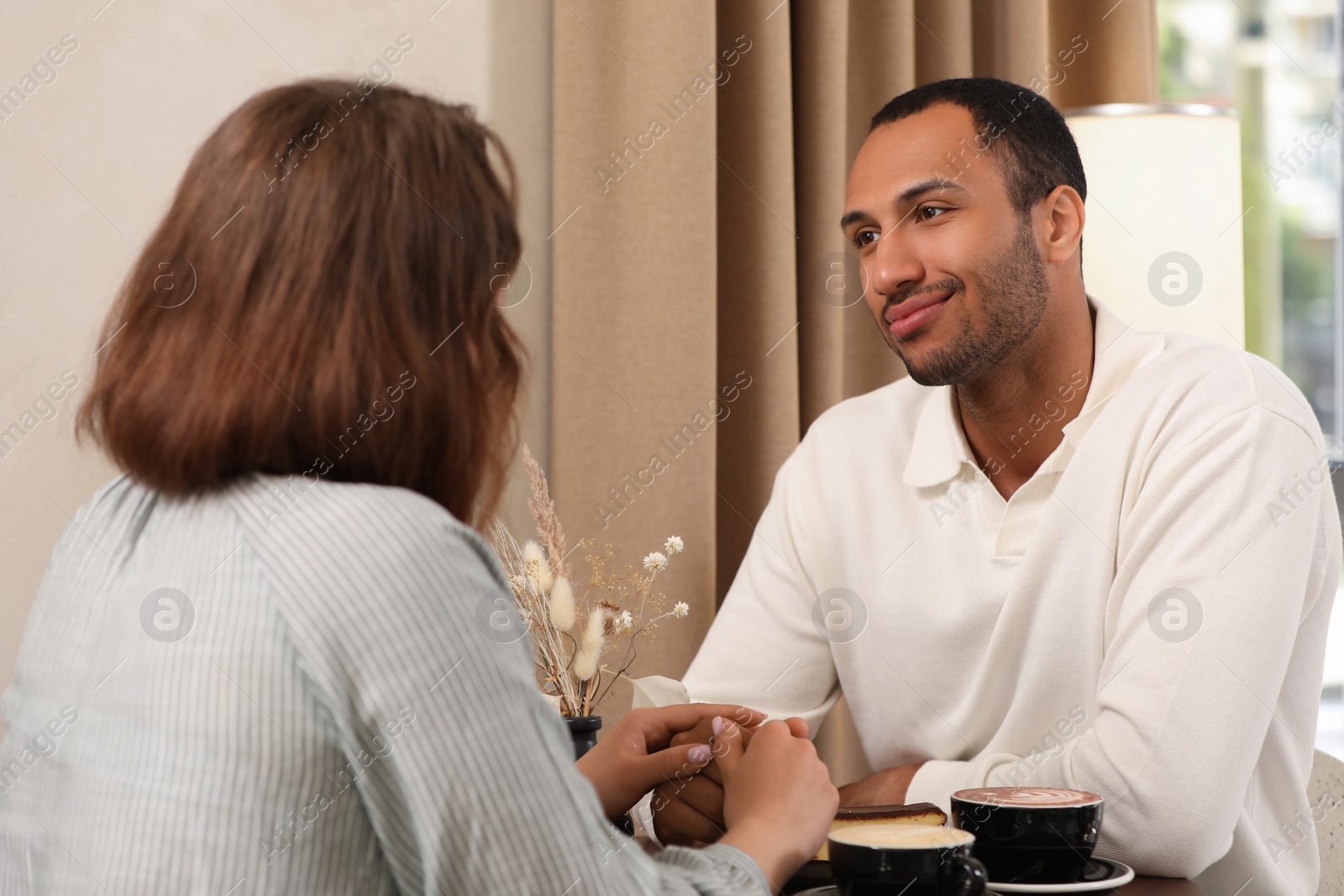 Photo of Romantic date. Happy couple spending time together in cafe