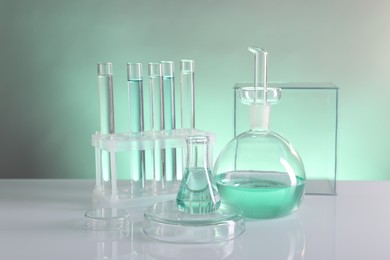 Photo of Laboratory analysis. Different glassware on table against color background