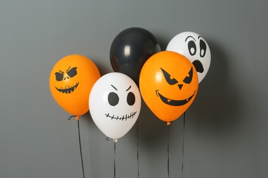 Photo of Color balloons for Halloween party on gray background