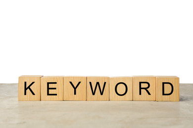 Photo of Wooden cubes with word KEYWORD on light table