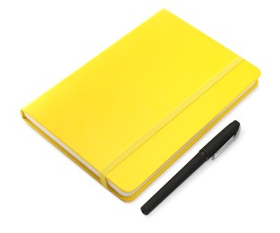 Photo of Closed yellow notebook with pen isolated on white