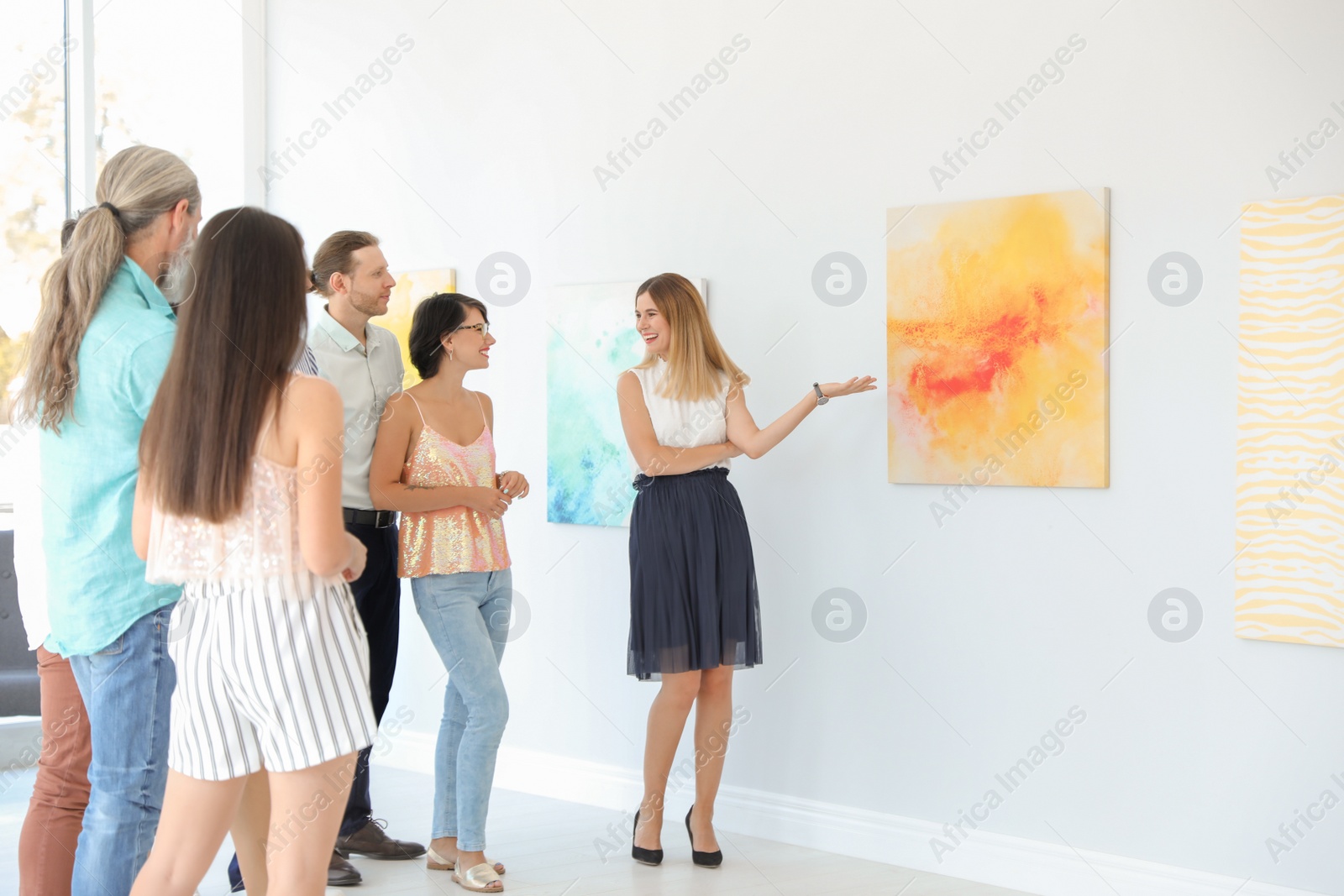 Photo of Group of people with guide at exhibition in art gallery