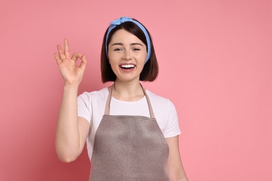 Happy confectioner showing ok gesture on pink background