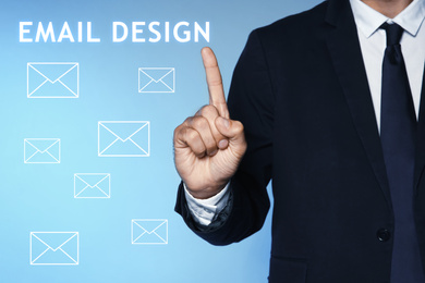 Image of Businessman pointing at phrase EMAIL DESIGN on virtual screen, closeup