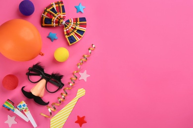 Photo of Flat lay composition with clown's accessories on pink background. Space for text