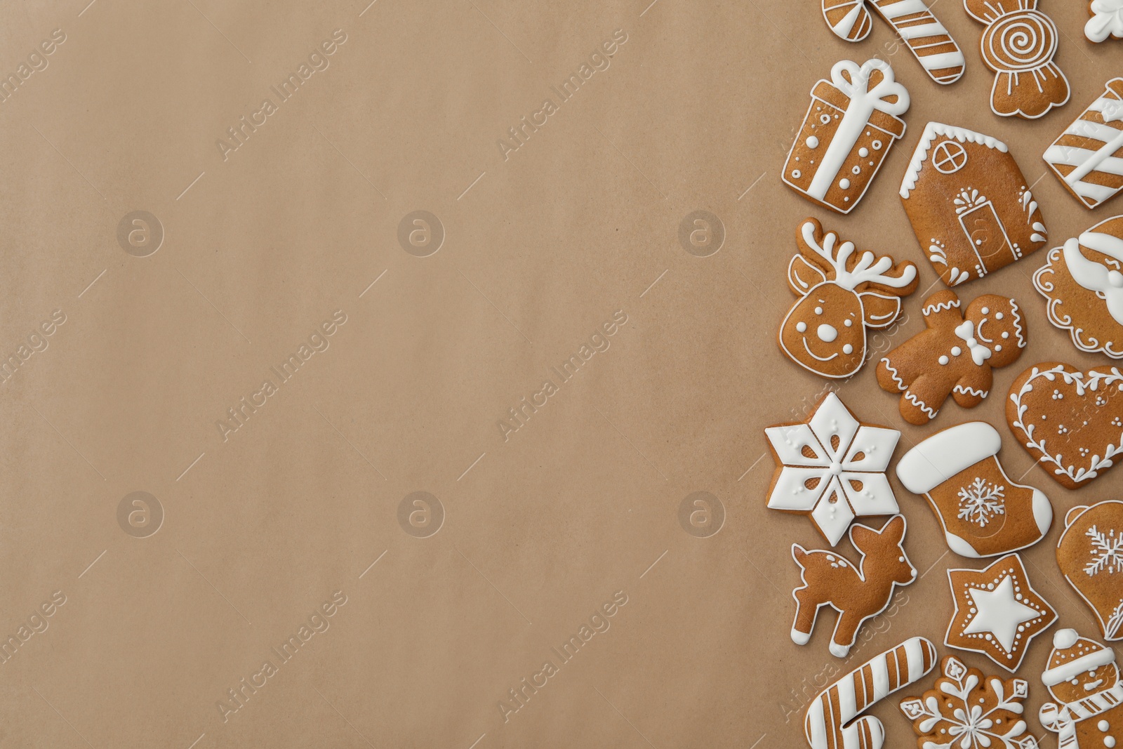 Photo of Different Christmas gingerbread cookies on brown background, flat lay. Space for text