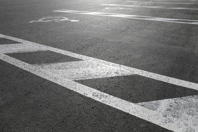 Photo of Car parking lot with wheelchair symbols outdoors