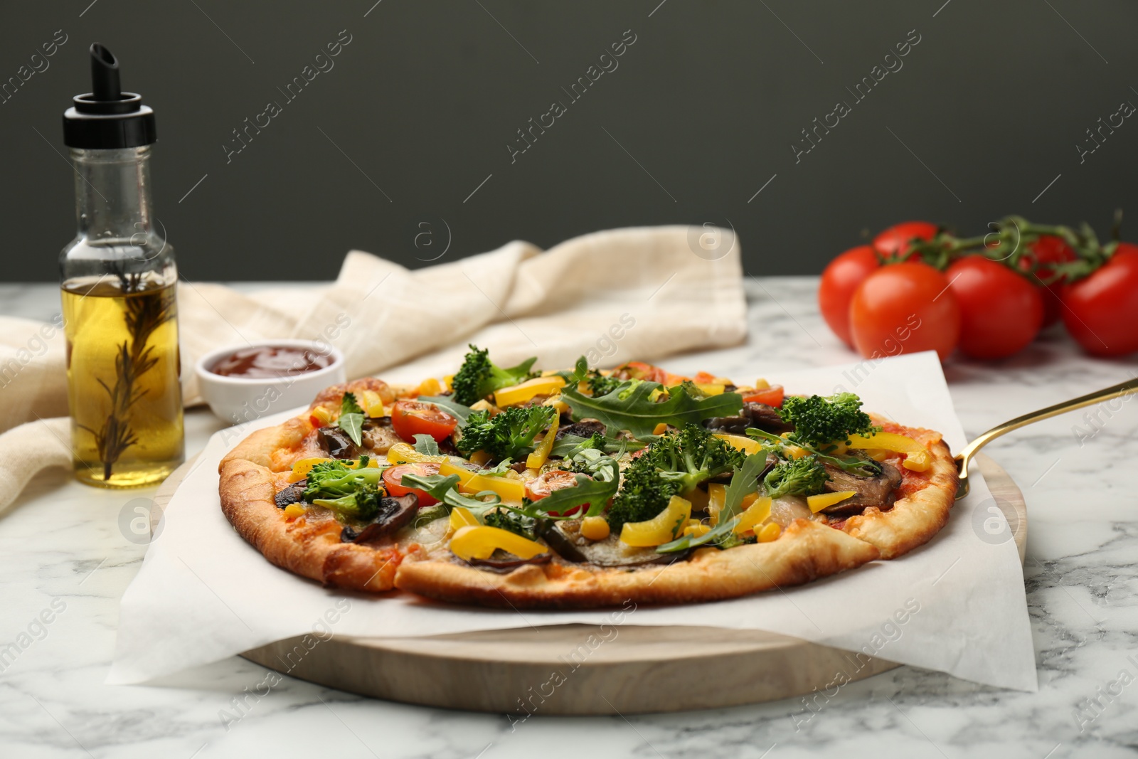 Photo of Delicious vegetarian pizza with mushrooms, vegetables and arugula on white marble table