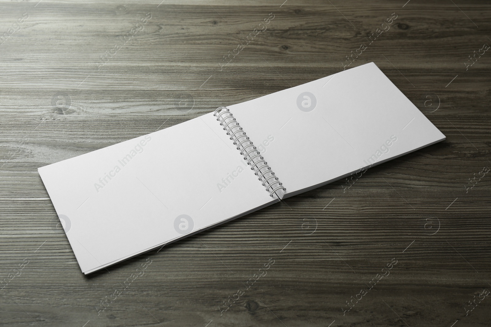 Photo of Blank paper brochure on wooden table. Mockup for design