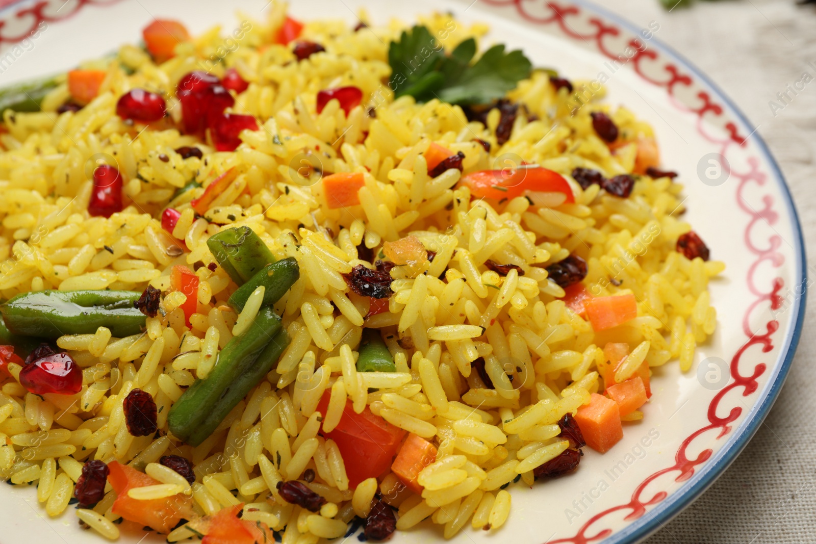 Photo of Tasty rice pilaf with vegetables on table, closeup