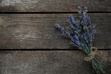 Photo of Bouquet of beautiful lavender flowers on wooden table, top view. Space for text