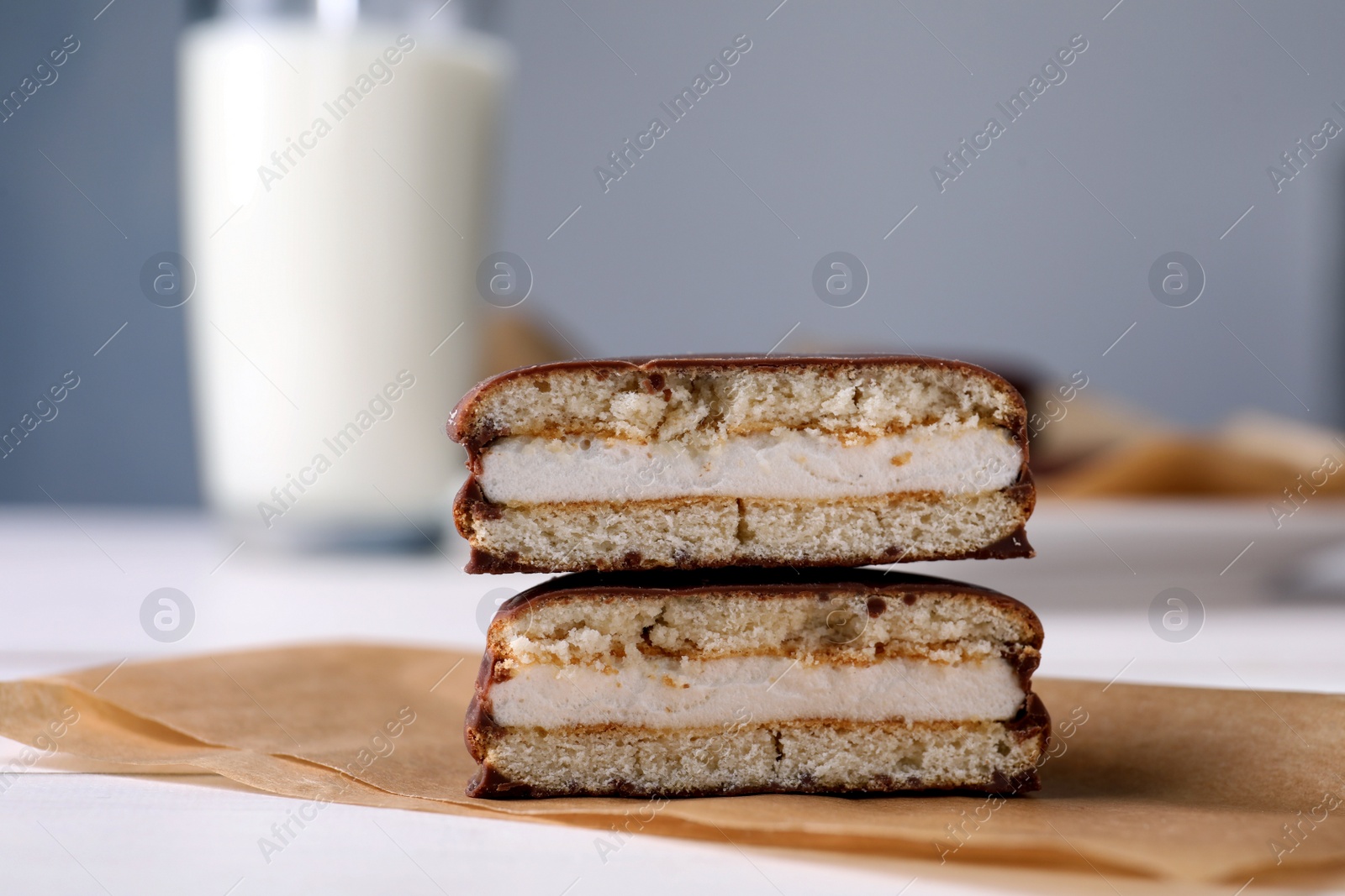 Photo of Tasty choco pies on parchment paper, closeup view