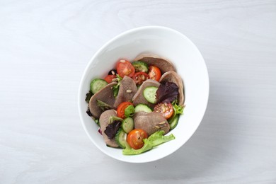 Photo of Delicious salad with beef tongue and vegetables on white wooden table, top view