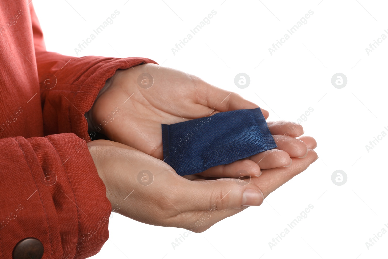 Photo of Woman holding hand warmer on white background, closeup