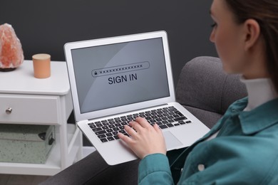Woman unlocking laptop with blocked screen indoors