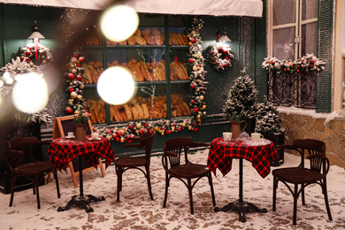 Photo of Beautiful outdoor cafe with festive decoration. Christmas celebration