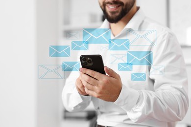 Image of Smiling man with smartphone chatting indoors, closeup. Many illustrations of envelope as incoming messages over device