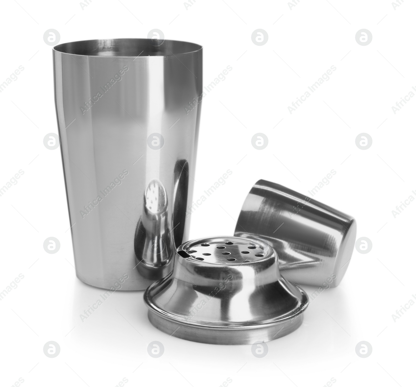 Photo of Metal cocktail shaker, strainer and cup isolated on white