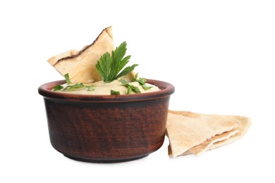 Delicious hummus with pita chips and parsley on white background