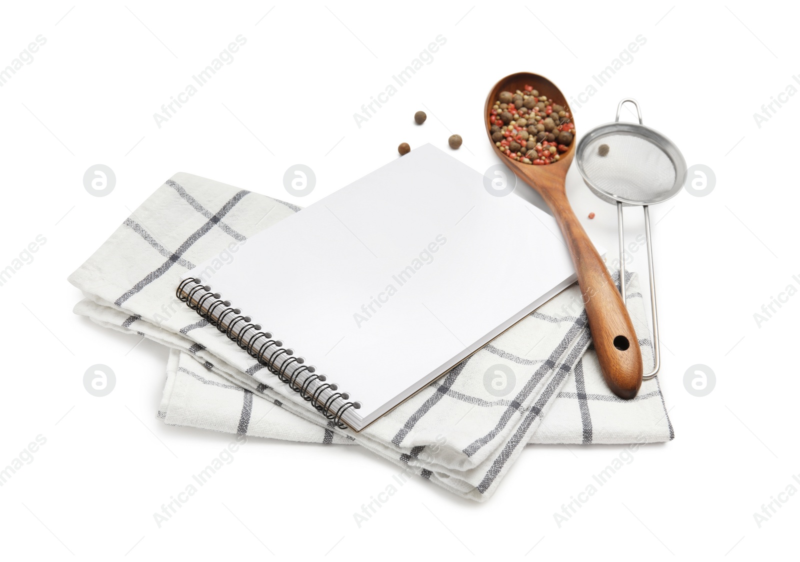 Photo of Blank recipe book, spices, napkin and kitchen utensils on white background. Space for text