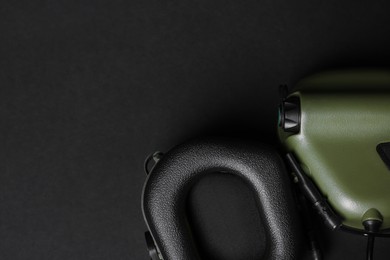 Tactical headphones on black background, flat lay with space for text. Military training equipment