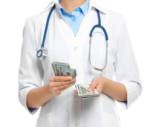 Doctor with bribe on white background, closeup. Corruption in medicine