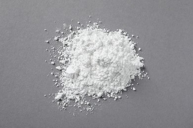 Photo of Heap of calcium carbonate powder on grey table, top view