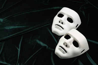 Photo of Theater arts. White masks on green fabric, above view. Space for text