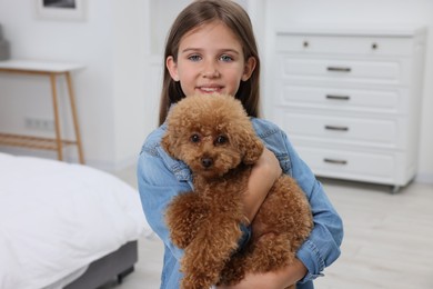 Photo of Little child with cute puppy at home. Lovely pet