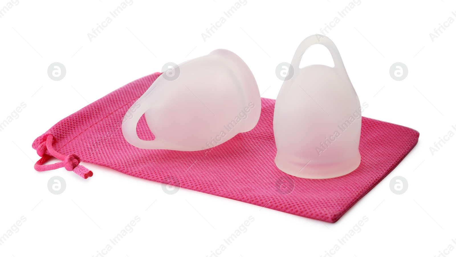 Photo of Silicone menstrual cups with pink bag on white background