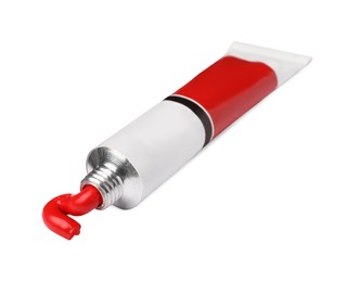 Photo of Tube with red oil paint on white background